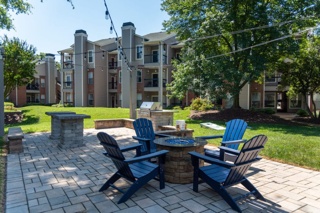 chairs around a fire pit on a patio