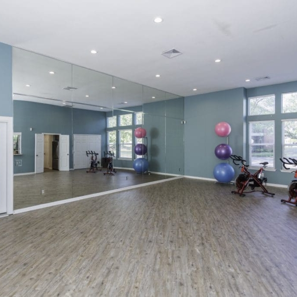 Large yoga room with bikes in the corner